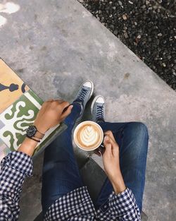 Low section of woman holding coffee cup