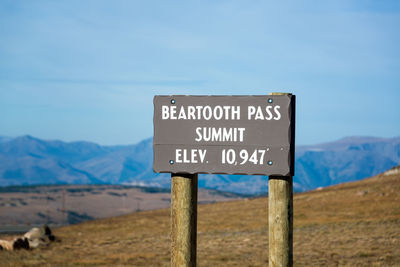 Close-up of information sign on landscape