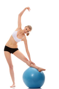 Full length of woman with arms raised against white background