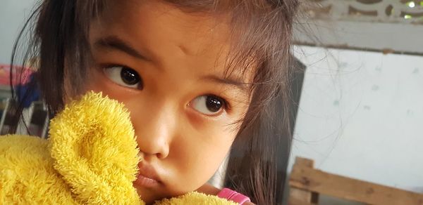 Close-up portrait of cute girl at home