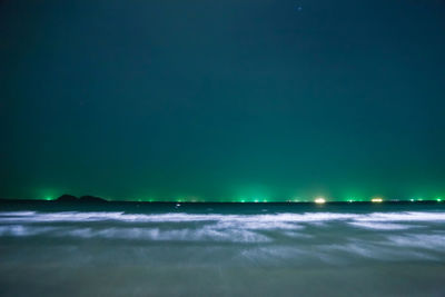 Scenic view of sea against clear sky at night