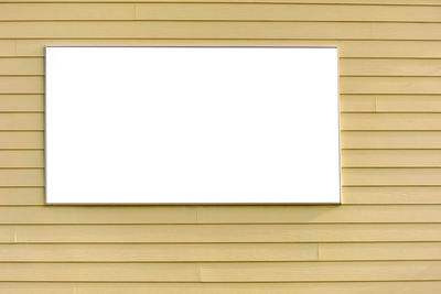 Close-up of blank picture frame on wall