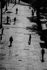 High angle view of people walking on footpath