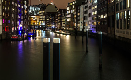 Reflection of illuminated buildings in city at night