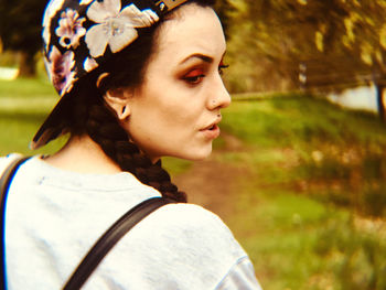 Rear view of young woman looking away in park