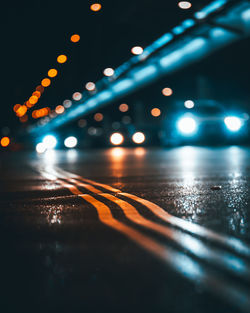 Dark bokeh on street while cars passing by.