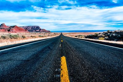 Road amidst landscape against sky