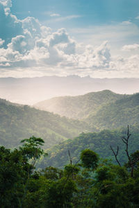 Scenic view of mountains against cloudy sky