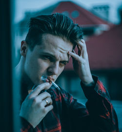 Portrait of young man holding camera