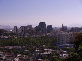 Modern buildings in city against clear sky