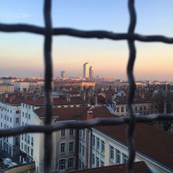 Cityscape against sky during sunset