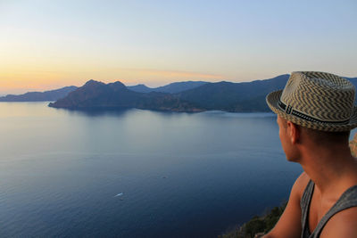 Portrait of man looking at mountains against sky