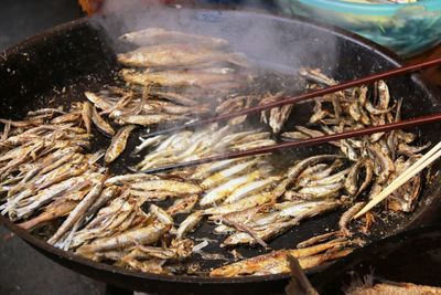 Close-up of fish frying in cooking utensil