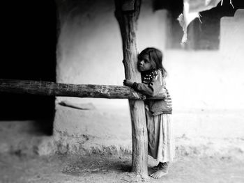 Full length of girl standing by building