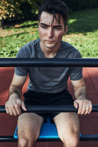 Portrait of young man having break during his workout in a modern calisthenics street workout park