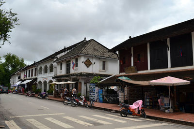 People walking on street against buildings in city