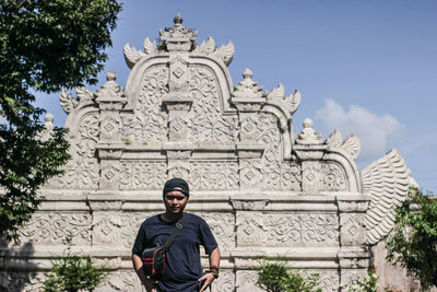 Portrait of statue against historic building