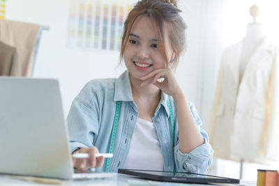 Businesswoman using laptop at office
