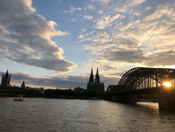 View of bridge over river against cloudy sky