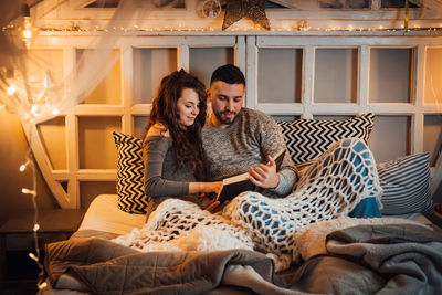 Young couple sitting at home