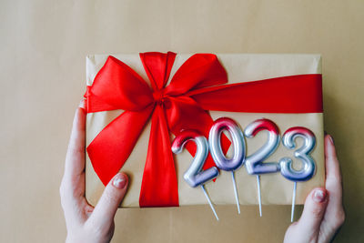 Cropped hands of woman holding gift box