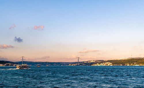 Sailboats in sea against sky