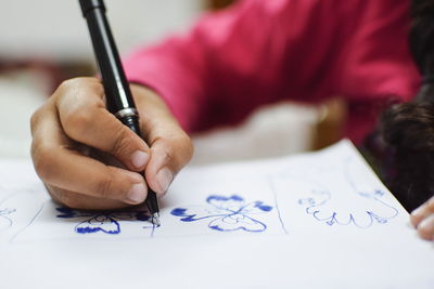 Close-up of human hand holding paper