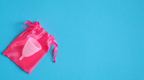 High angle view of red balloon against blue background