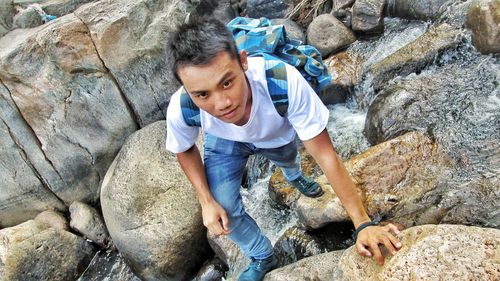High angle view of man climbing on rock