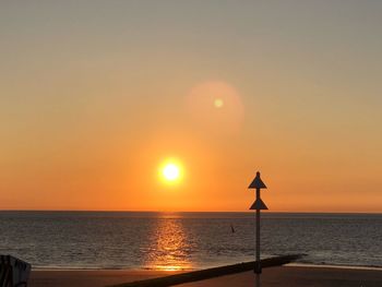 Scenic view of sea against orange sky