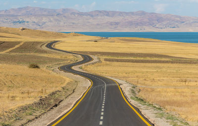 Panoramic view of road leading towards mountains