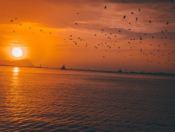 Scenic view of sea against romantic sky at sunset