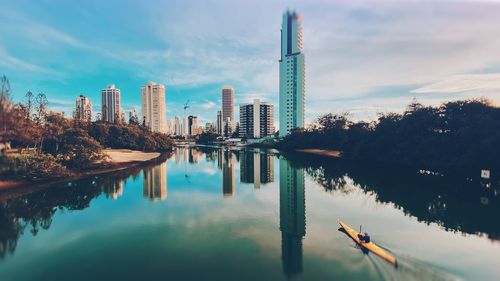 Panoramic view of lake and buildings against sky