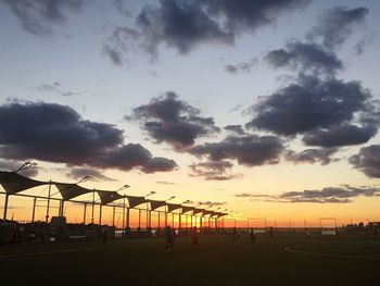 Scenic view of sea against cloudy sky at sunset