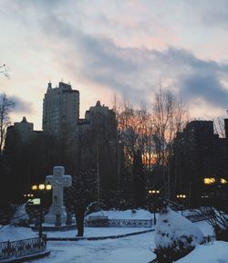 Snow covered city against sky