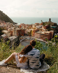 Rear view of woman looking at buildings in city