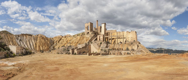 Panoramic view of castle against cloudy sky