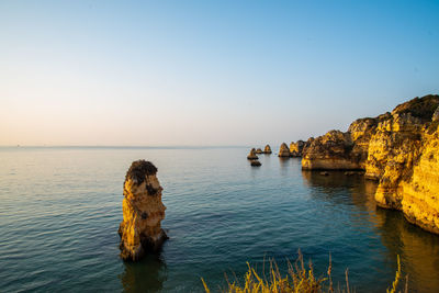 Scenic view of sea against clear sky at sunset