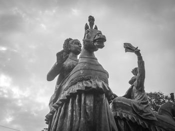 Low angle view of statue against cloudy sky