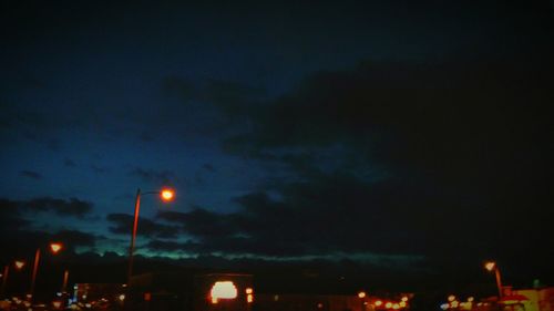 Illuminated trees against sky at night