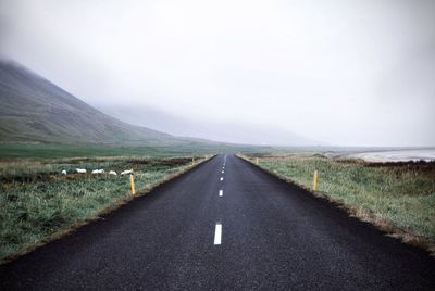 Road passing through landscape against sky