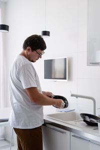 Young man standing at home