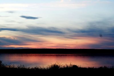 Scenic view of lake against sky during sunset