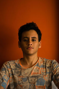 Portrait of young man against gray background