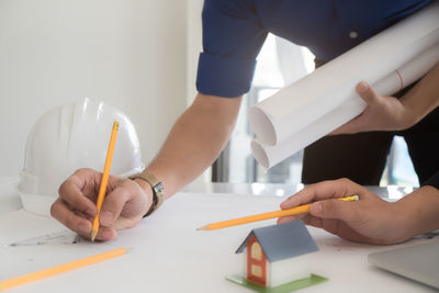 Midsection of man working on table