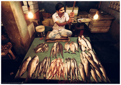 High angle view of man sitting at table