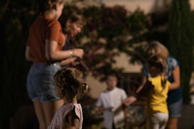 Rear view of people dancing outdoors