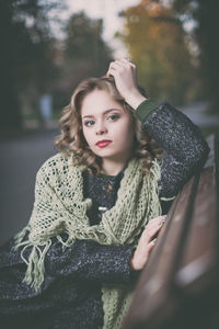 Portrait of young woman sitting outdoors