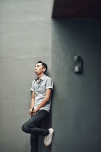 Boy standing against wall