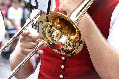 Midsection of man playing musical instrument 